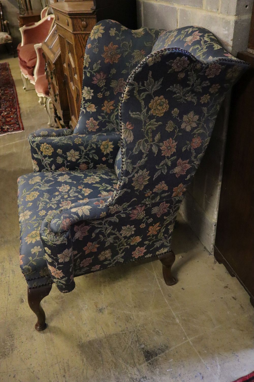 A George I style mahogany framed wing armchair